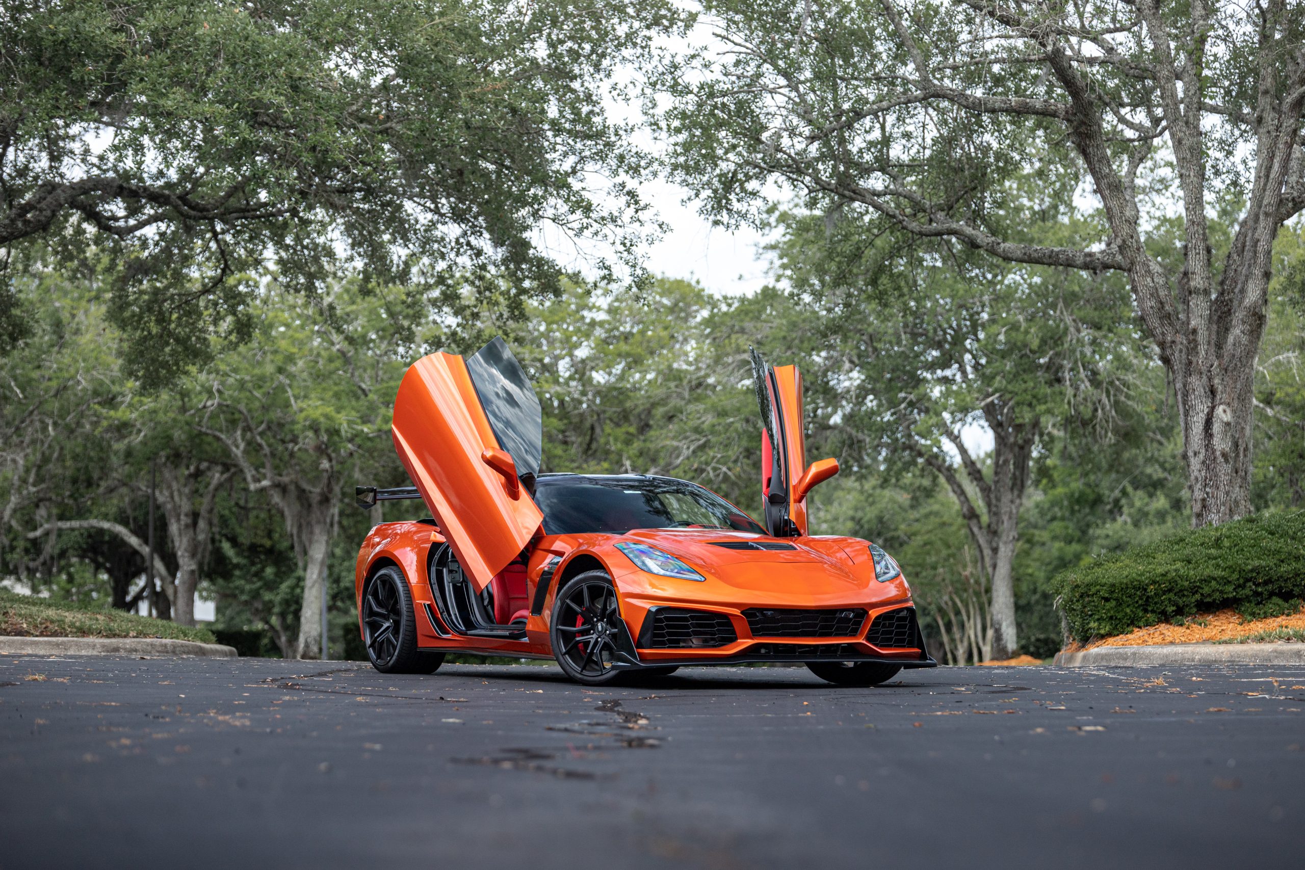 Orange sports car with scissor doors.