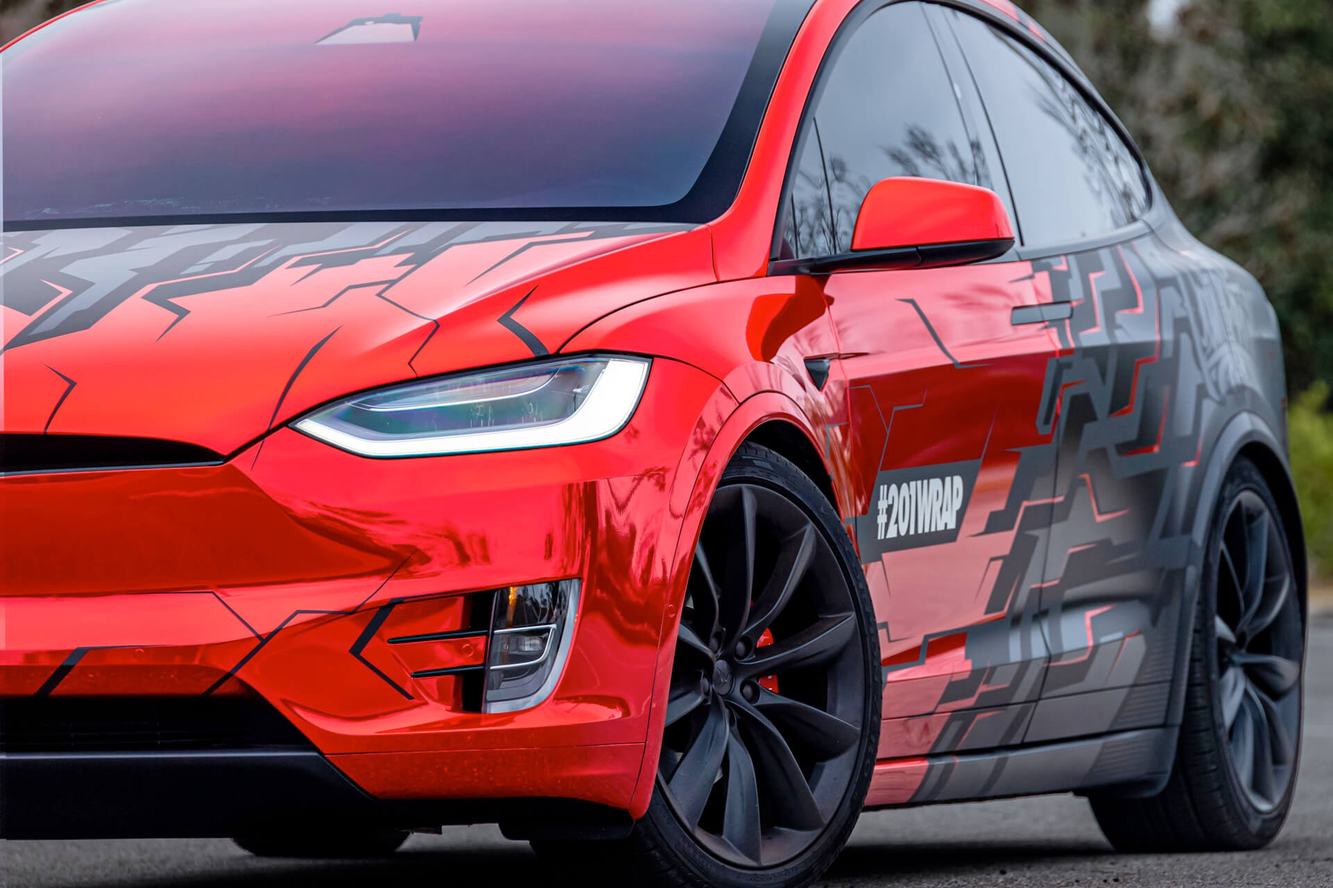 A red and black Tesla SUV.