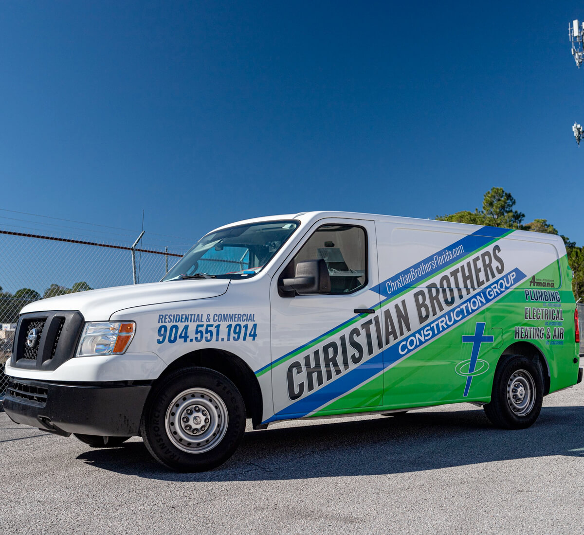 White Nissan van with a construction group business logo