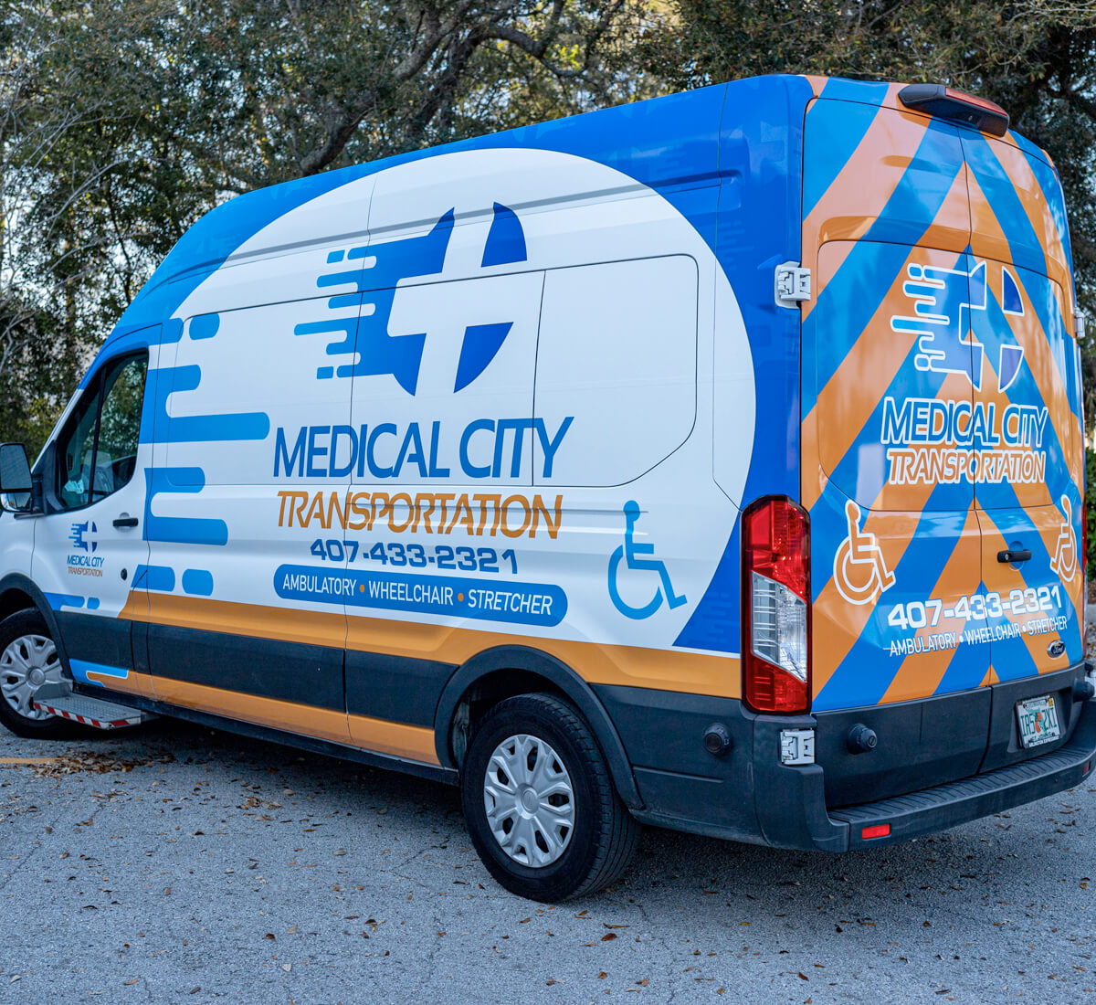 White and blue transit van with business graphics