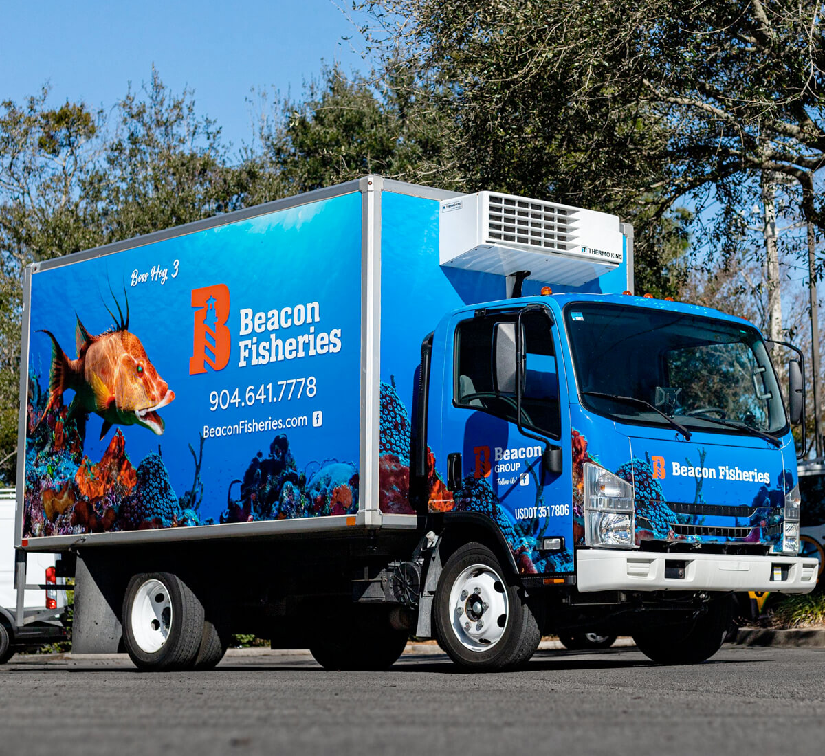 Box truck with business beacon fisheries wrap design