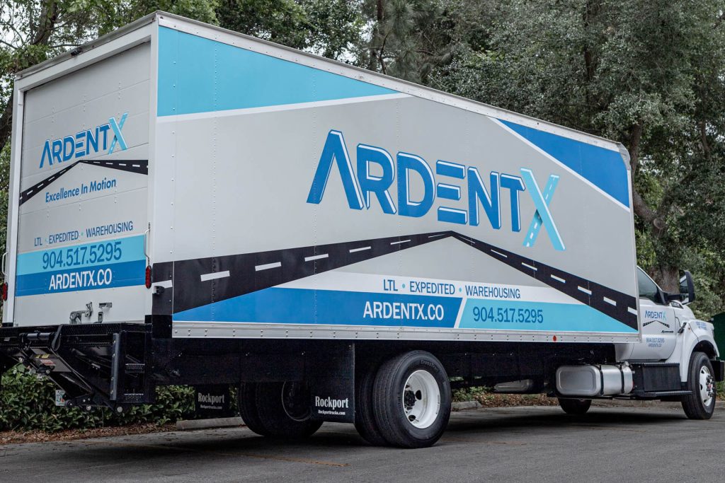A box truck with local business graphics.